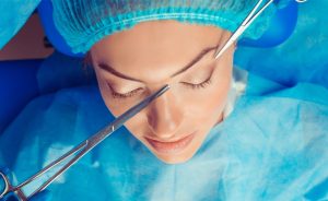 Patient undergoing brow lift surgery to raise and rejuvenate the forehead area